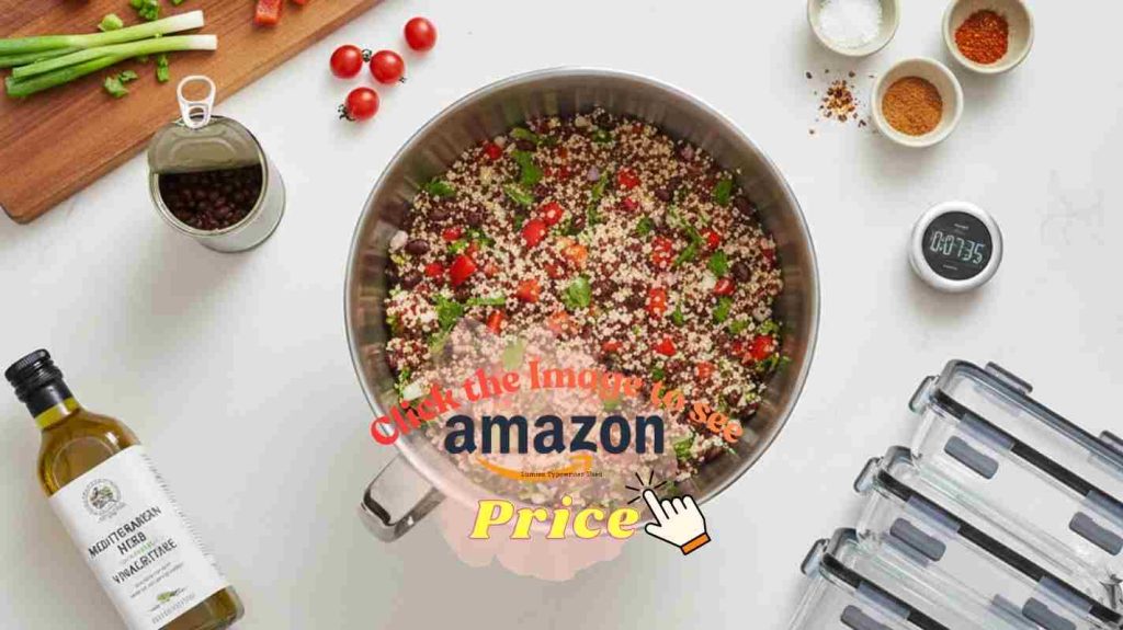 8qt mixing bowl filled with colorful quinoa salad surrounded by meal prep ingredients and storage containers.