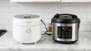 Cuckoo vs Aroma rice cookers side by side on modern kitchen counter